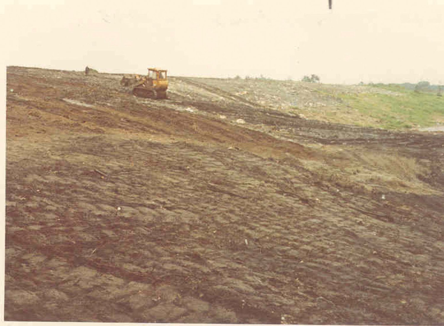 IN ACTION:  This photograph taken by Larry Coletta on Aug. 7, 1975, shows the extent of the landfill when the buffer area to the neighborhood had been virtually removed.
